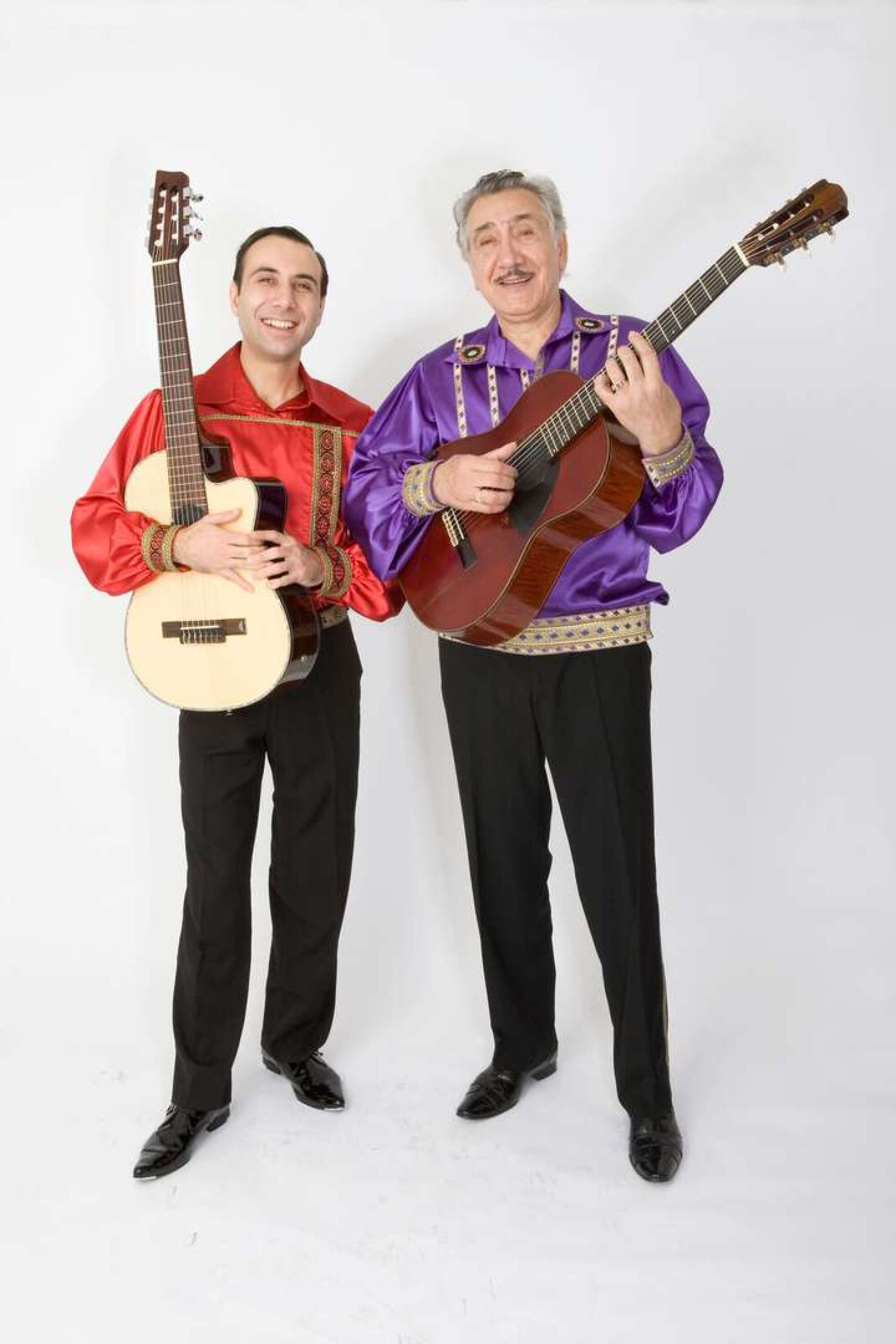Two men holding guitars