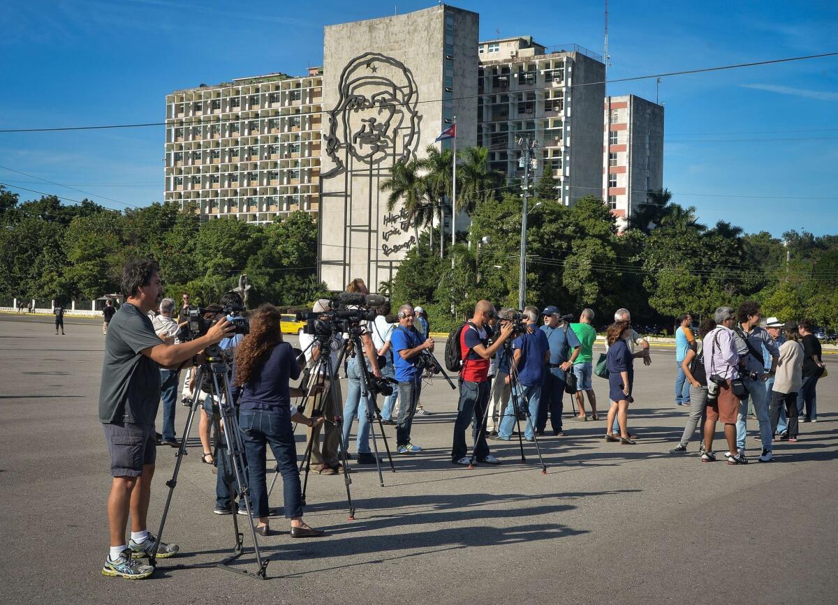 Journalists wait for Cuban performance artist Tania Bruguera at Revolution Square in Havana on Tuesday. Bruguera had announced that she would set up an open mic for ordinary citizens to express their views. According to her family, the artist was detained before the activity could be held.