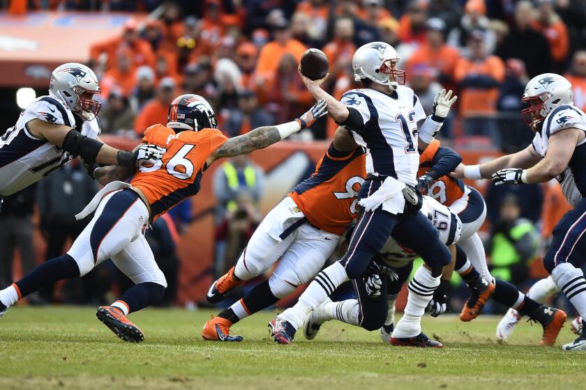 Broncos linebacker Shane Ray reaches for Patriots quarterback Tom Brady as he attempts to pass during the second half of the AFC championship game.