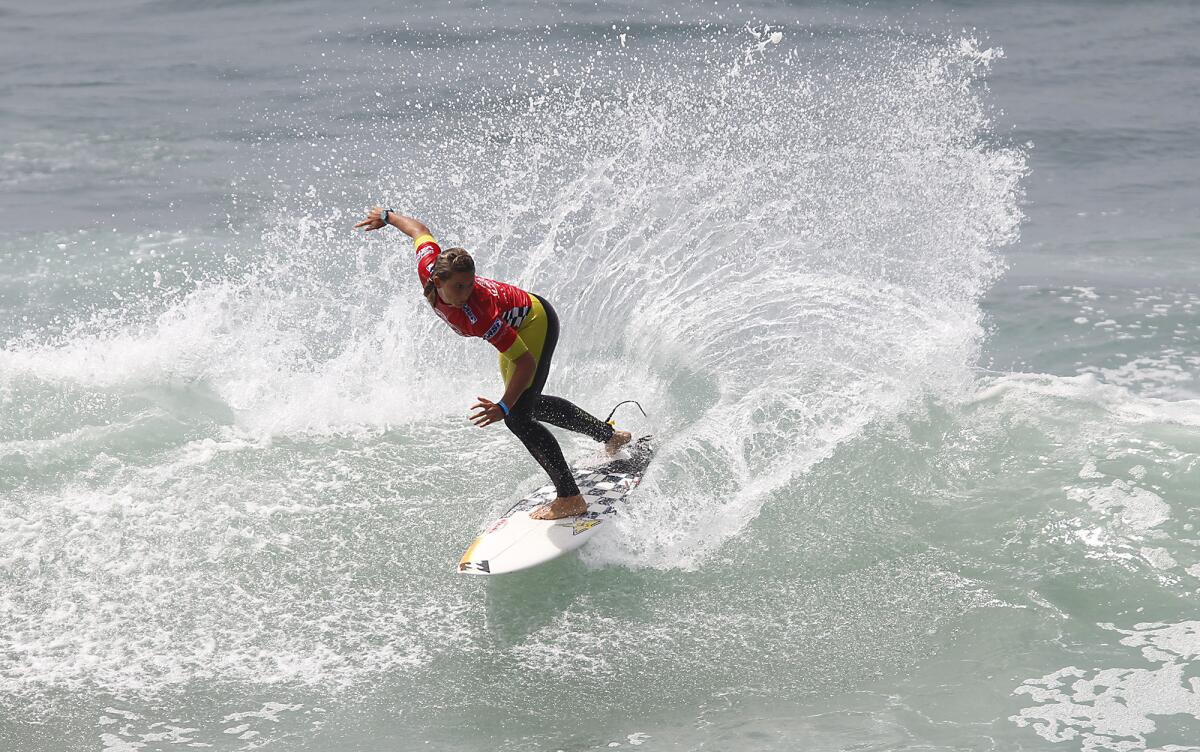 Courtney Conlogue rips a backhand snap as she surfs in Round 1 of the women's division of the 2013 Vans US Open of Surfing at the Huntington Beach Pier on Tuesday.