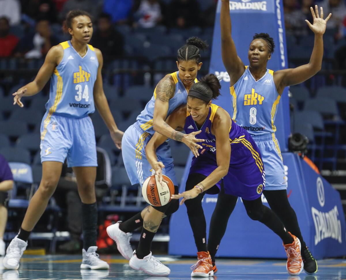 Sky forward Tamera Young, second from left, defends against Sparks forward Candace Parker, second from right, during the second half of Game 3 of the WNBA semifinals on Oct. 2.