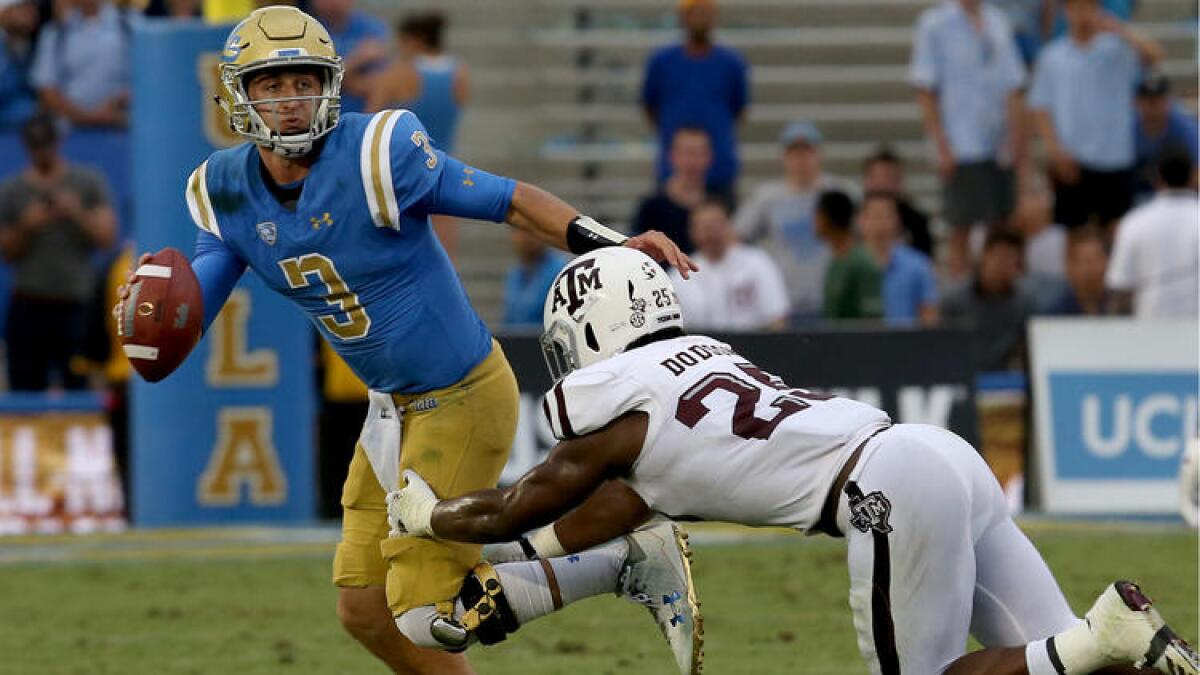 UCLA quarterback Josh Rosen tries to scramble away from the pressure of Texas A&M linebacker Tyler Dodson in the second quarter.