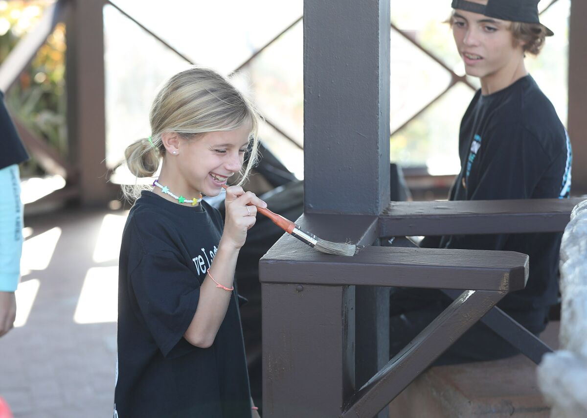 Summer Samuelian and her brother, Charlie, paint portions of the Heisler Park gazebo.
