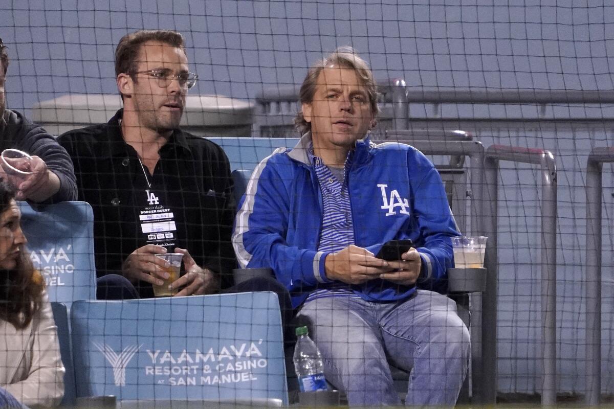 Dodgers co-owner Todd Boehly, right, watches the team play the Detroit Tigers on April 30.