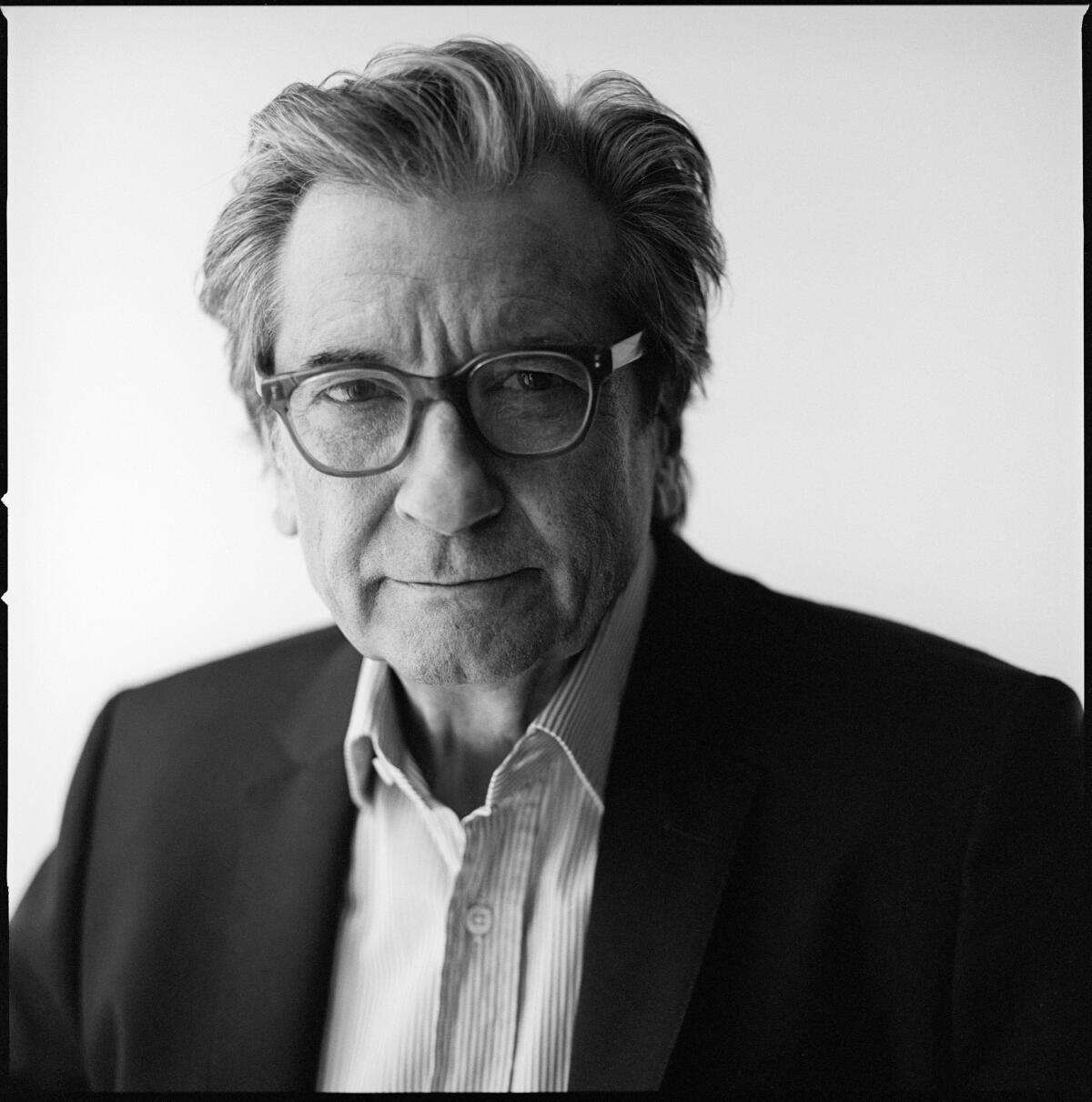 A black-and-white photo portrait of Griffin Dunne looking into the camera