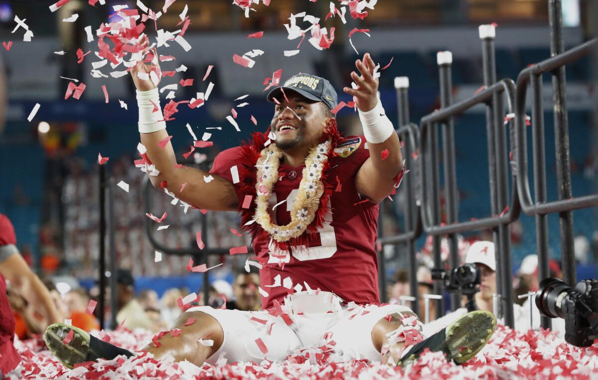 Alabama quarterback Tua Tagovailoa throws confetti in the air after winning the Orange Bowl against Oklahoma on Dec. 30, 2018 in Miami Gardens, Fla.