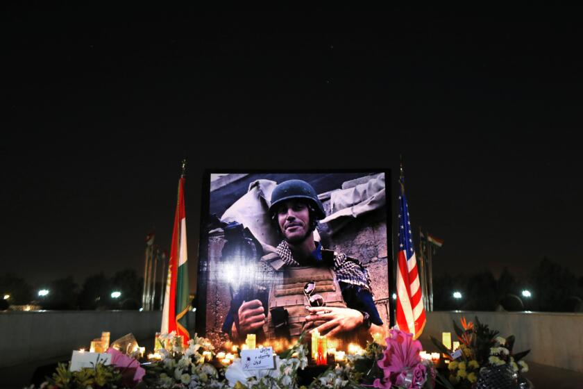 A photograph of James Foley, the American journalist killed by Islamic State militants, is displayed during a memorial service in Irbil, in northern Iraq on Aug. 24.