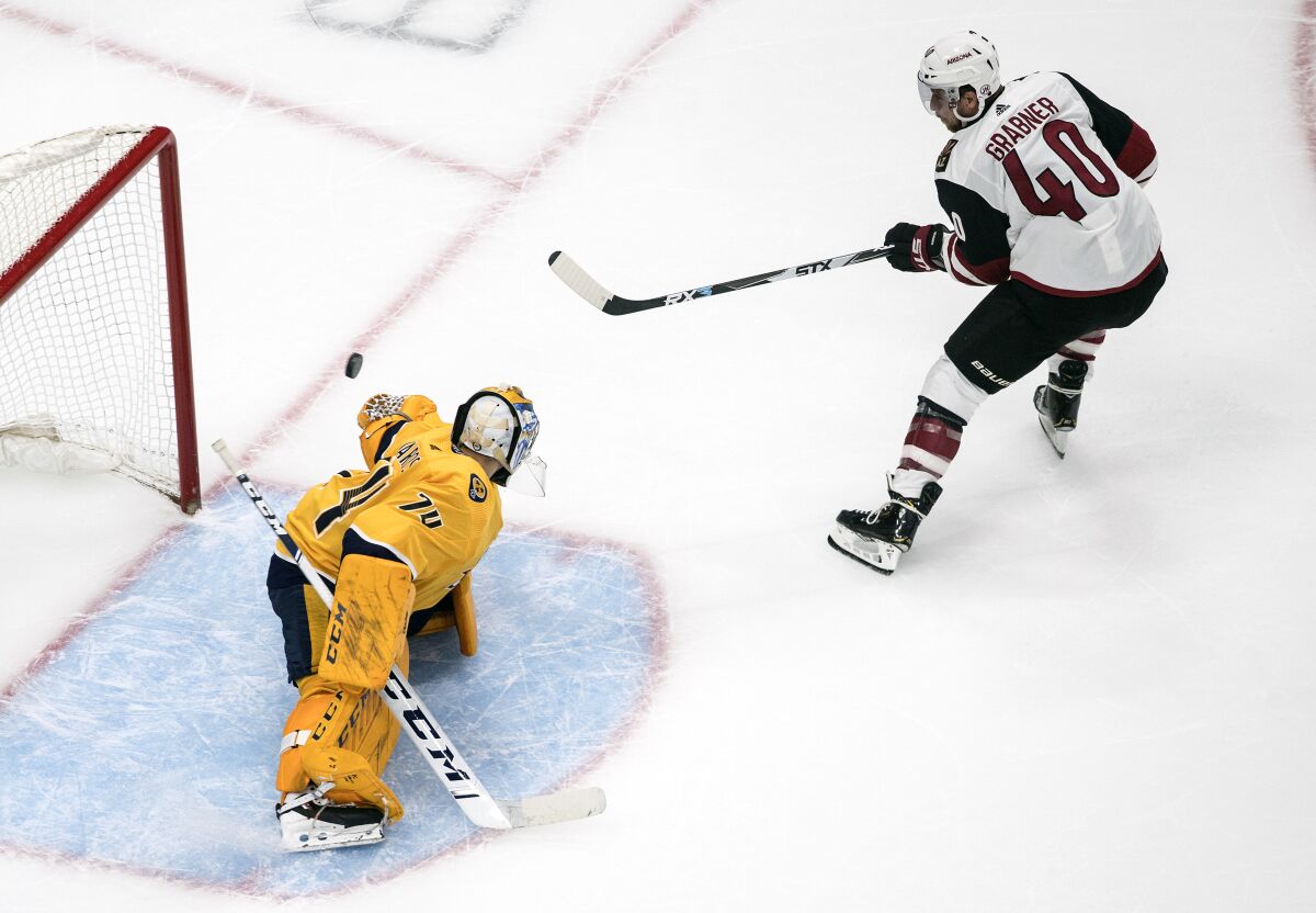 Nashville Predators goalie Juuse Saros (74) is scored against by Arizona Coyotes' Michael Grabner (40) during second-period NHL hockey Stanley Cup qualifying round game action in Edmonton, Alberta, Sunday, Aug. 2, 2020. (Jason Franson/The Canadian Press via AP)