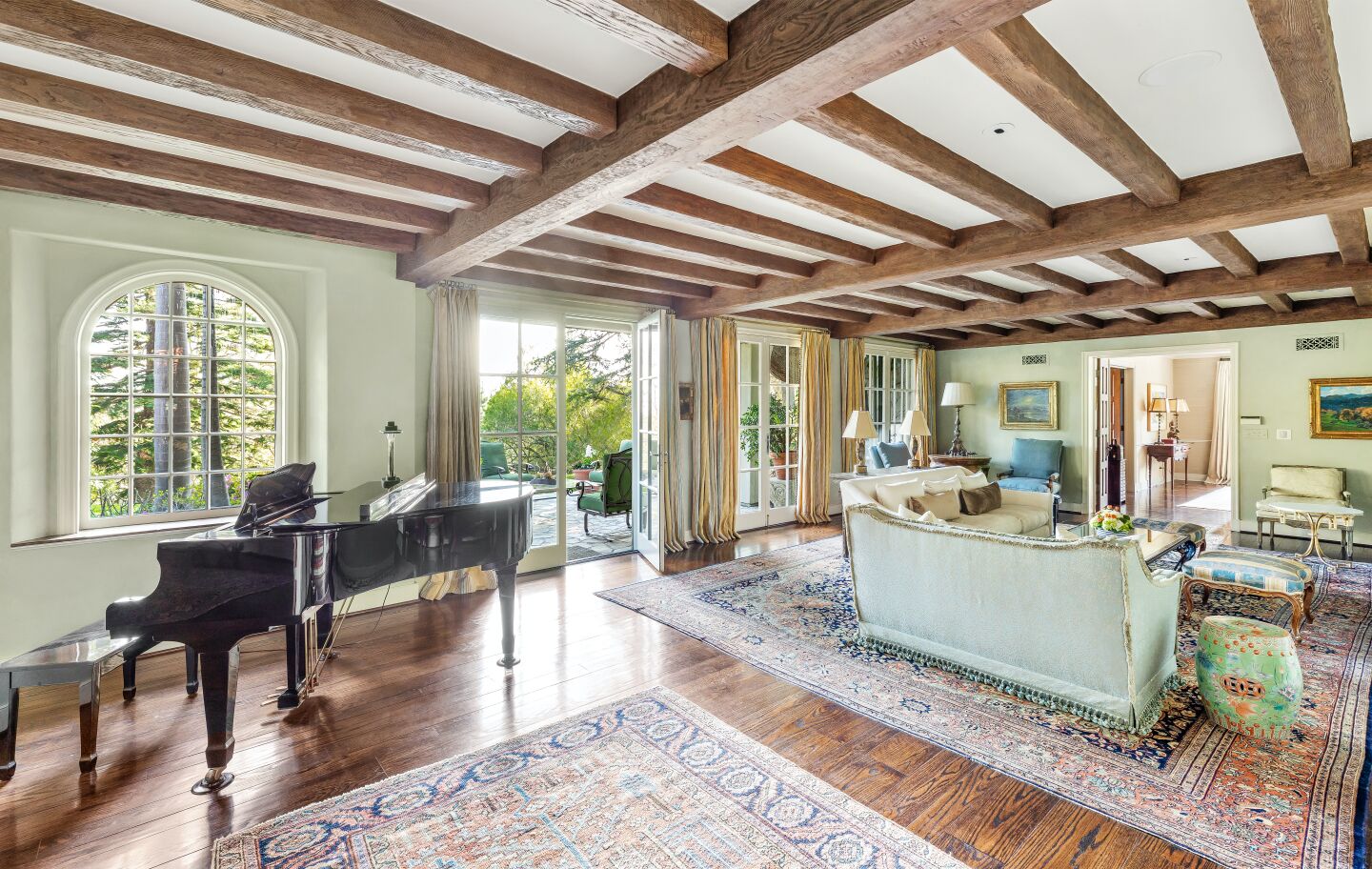 A grand piano sits in the living room.