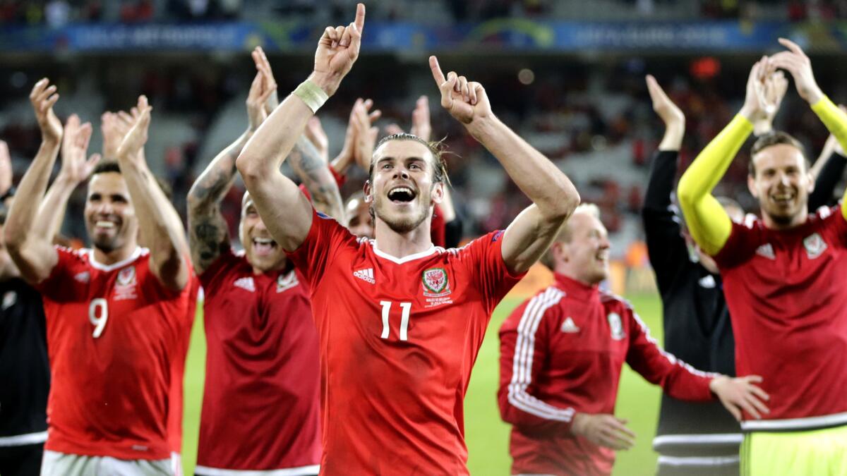 Gareth Bale (11) and his Welsh teammates celebrate after their 3-1 victory over Belgium on Friday.