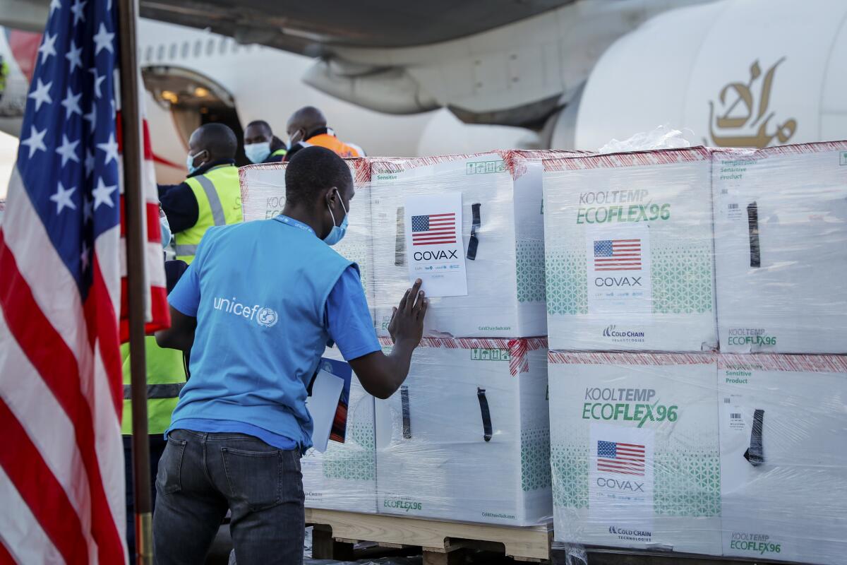 A UNICEF worker checks boxes of COVID-19 vaccine after their arrival at the airport in Nairobi, Kenya.