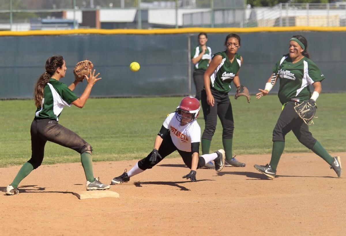 Estancia High's Bree Vernon, bottom center, is safe at second base after Costa Mesa's Anessa Farldow, far right, miss throws the ball to teammate Brenna Alvis, far left, in an Orange Coast League game on Tuesday.