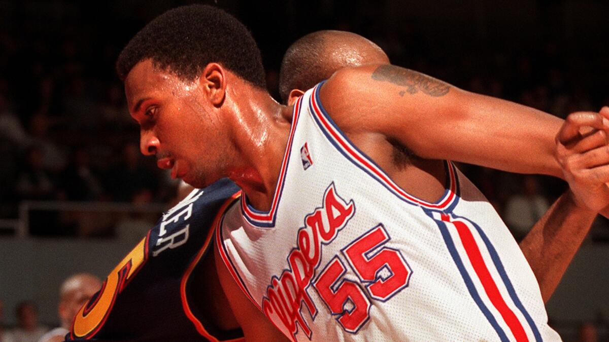 Clippers forward Lorenzen Wright scrambles for the ball during a game against the Golden State Warriors in 1999