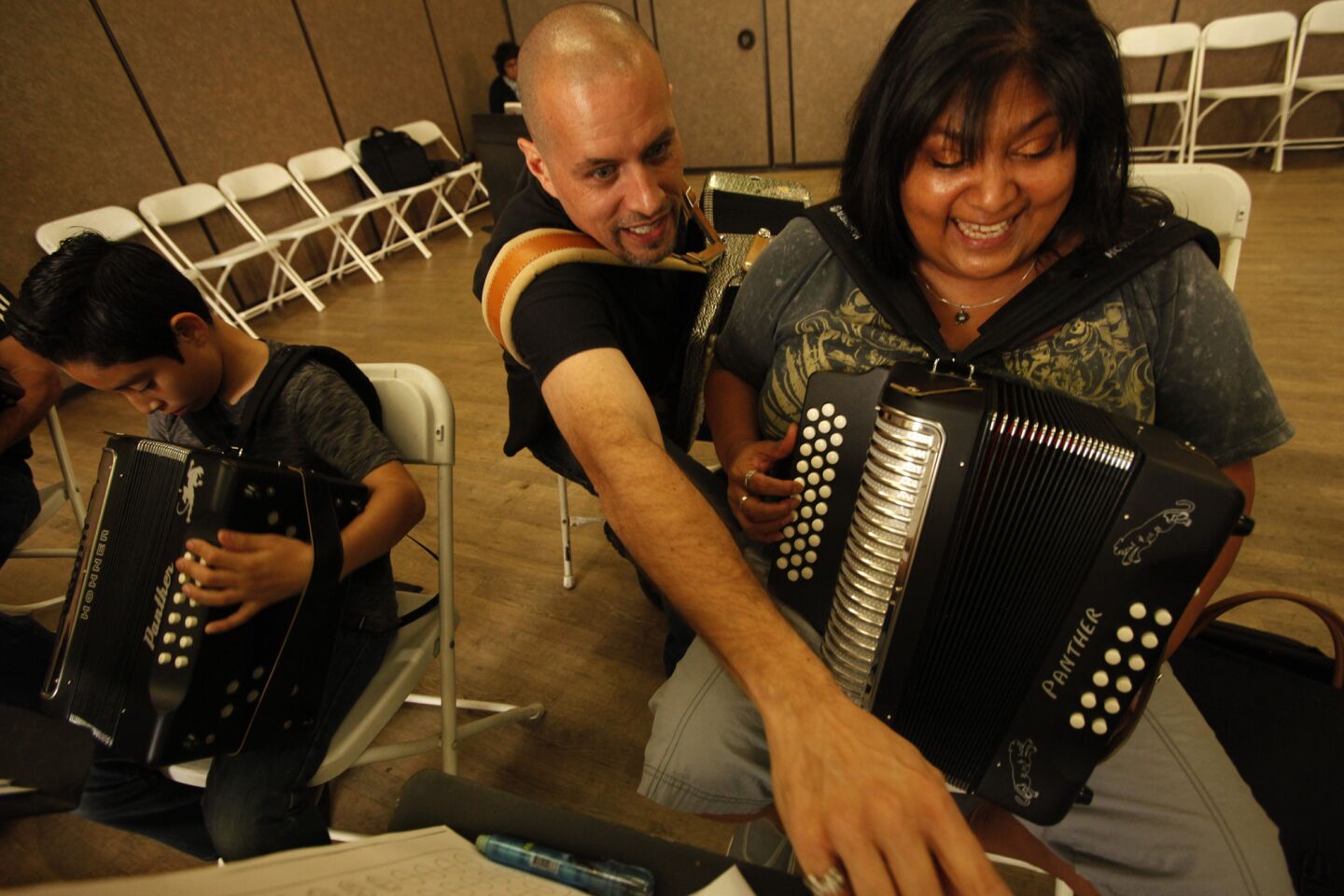 Otono Lujan helps student Sylvia Gonzales with a new song while teaching his weekly Saturday morning class on playing the button accordion. Lujan, who plays in a band called Conjunto Los Pochos, has been teaching students how to play the accordion for many years.