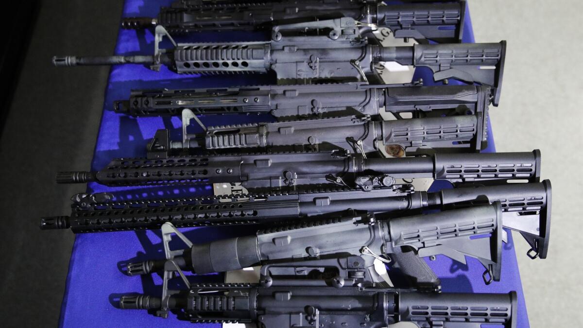Firearms are on display during a news conference at the Hollywood Community Police Station Thursday. More than 40 firearms were seized in a recent joint task force operation, authorities said Thursday.
