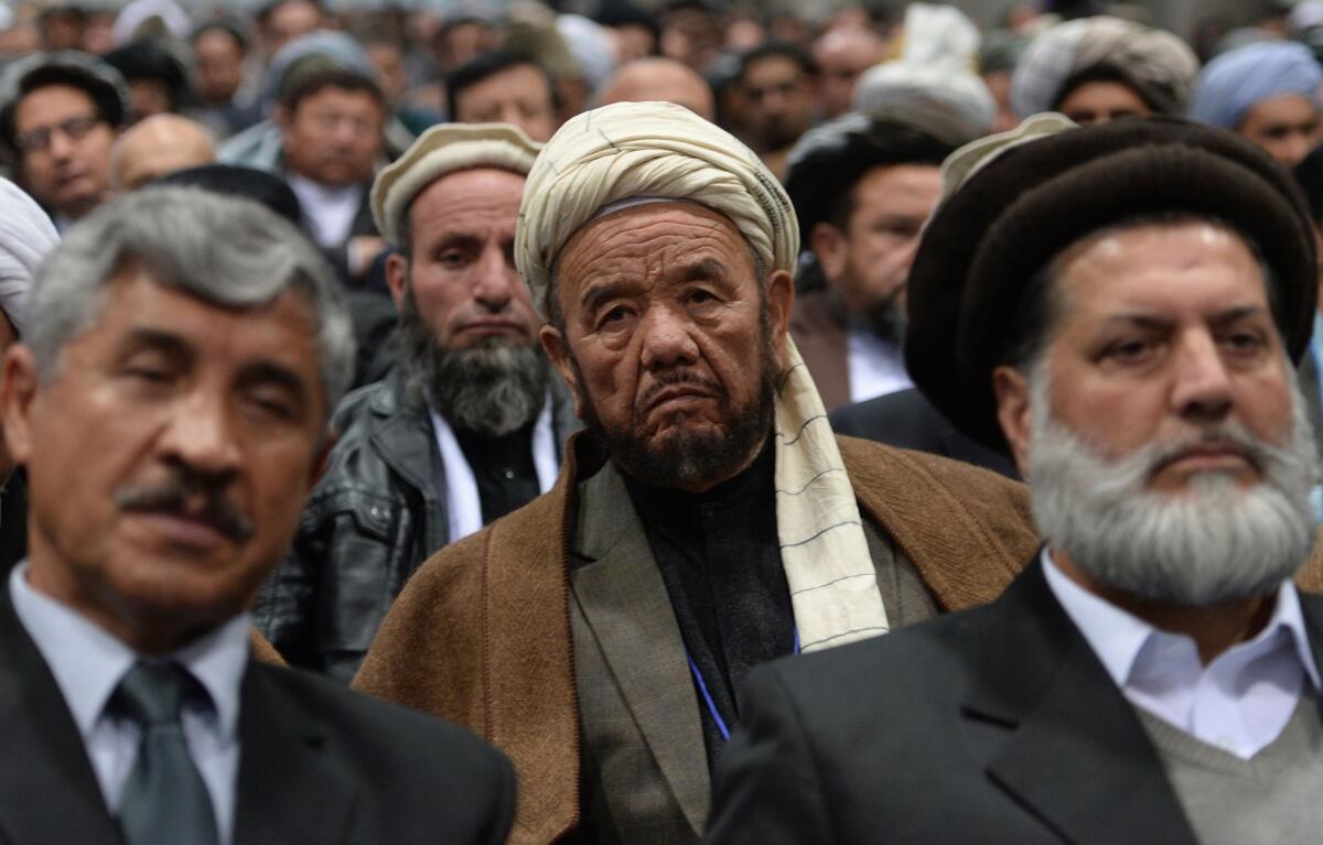 Members of the Afghan loya jirga, a meeting of about 2,500 Afghan tribal elders and leaders, listen Thursday during the first day of a four-day gathering in Kabul.
