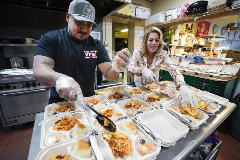 San Diego, CA - April 26: On Friday, April 26, 2024 in San Diego, CA, at the VFW Post 7420 in Barrio Logan, Veronica Aguilera and Eric Gonzalez prepared and package more than 75 meals. The meals when completed will delivered to flood victims from the January 22nd flood in Southcrest. The organization prepares the meals from donations given to the post to be used for the victims from the flood. (Nelvin C. Cepeda / The San Diego Union-Tribune)