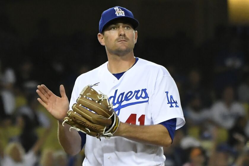 Los Angeles Dodgers relief pitcher Daniel Hudson reacts after New York Mets' Eduardo Escobar.