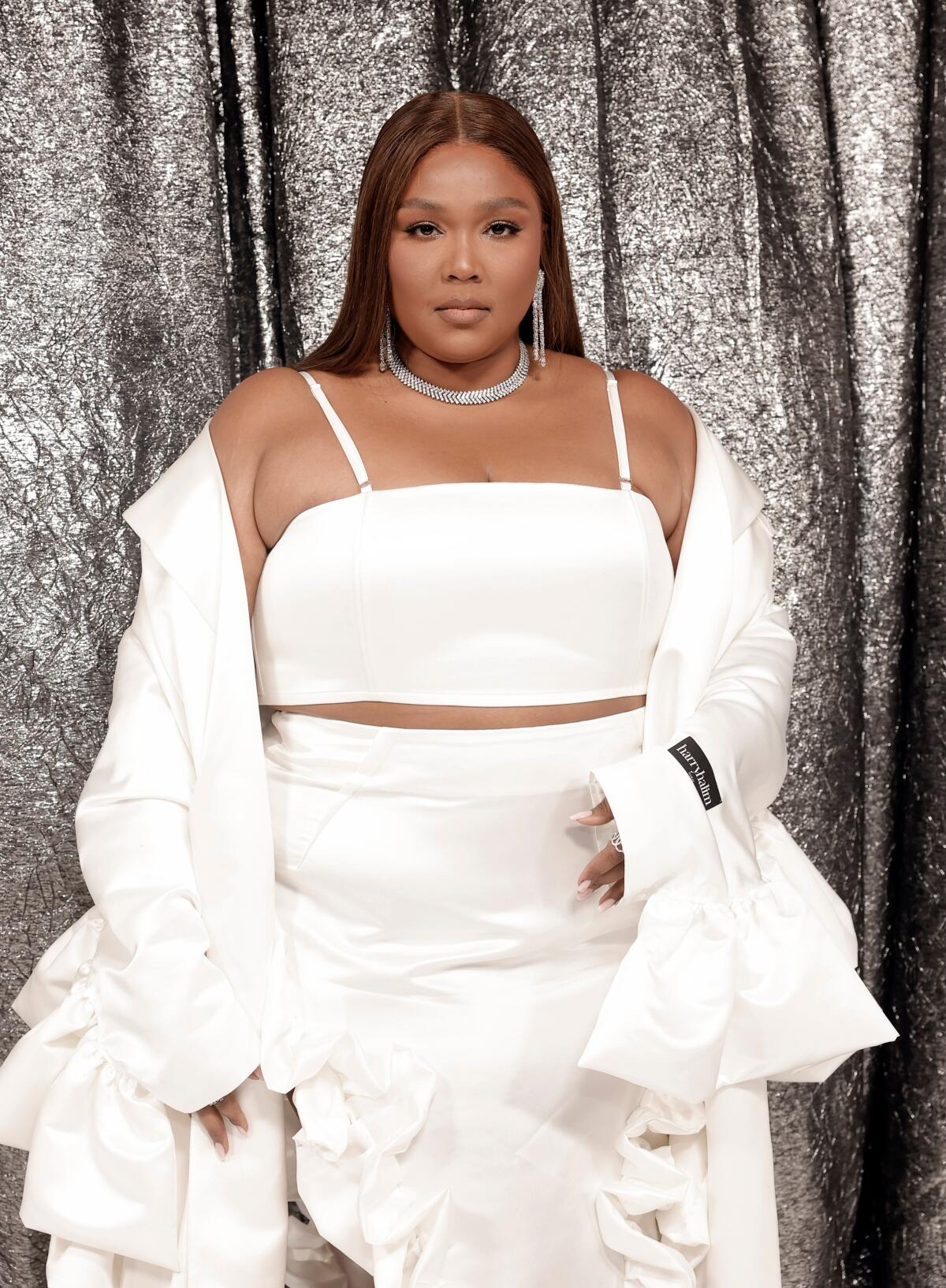 Lizzo in a white dress on the red carpet
