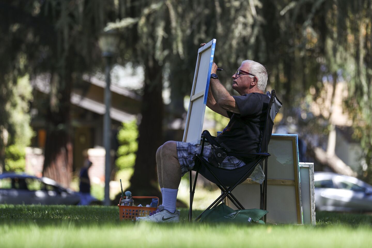 On a hot and sunny Tuesday, John Call finds shade under a tree to paint at Kuns Park in La Verne.