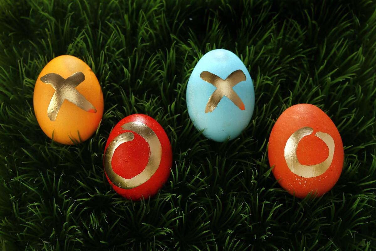 Easter eggs decorated with Kool-Aid dyes and gold paint pens.
