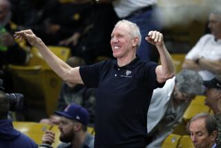 Bill Walton smiles as he acknowledges fans before covering a Pac-12 basketball game