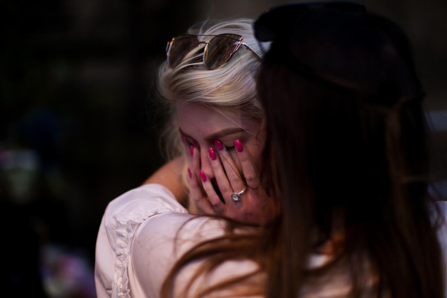 People cry after a vigil in Albert Square in Manchester, England, on May 23, 2017, the day after a suicide attack at an Ariana Grande concert that left 22 people dead.