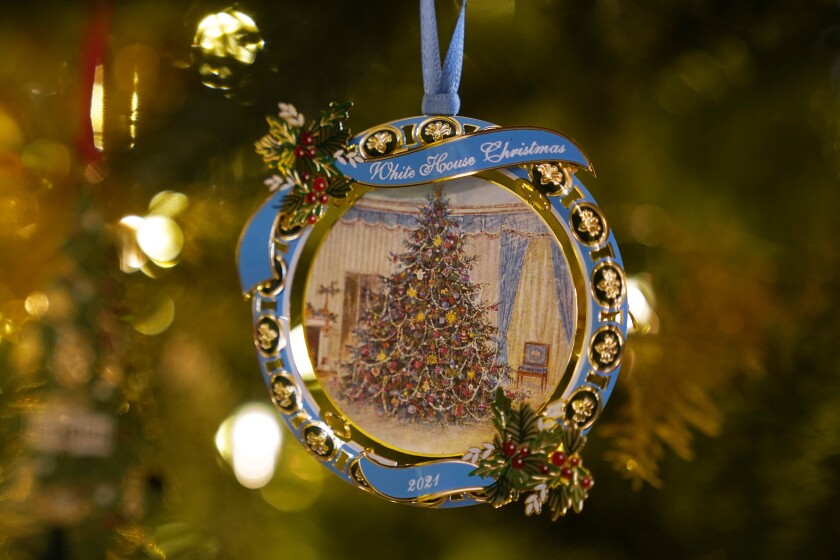 The White House Historical Association's 2021 Christmas tree ornament that honors President Lyndon Johnson hangs on a tree in the St. Regis Hotel in Washington, Friday, Dec. 10, 2021. The 2021 official White House ornament, the 41st in the series, honors President Johnson with its reproduction of a painting of the Blue Room tree the family had in December 1967. (AP Photo/Susan Walsh)