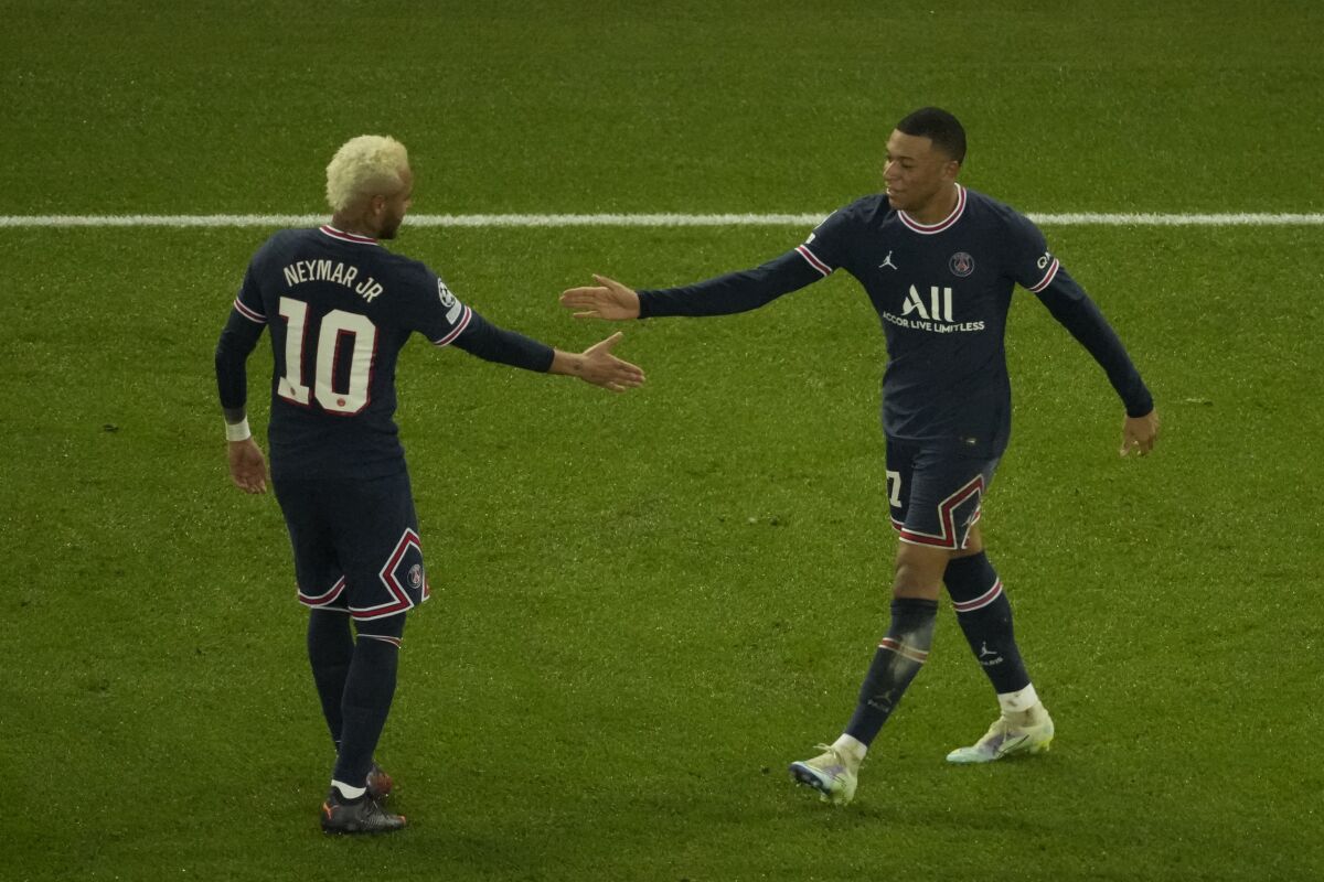 PSG's Kylian Mbappe celebrates with his teammate Neymar after scoring his side's opening goal during the Champions League, round of 16, first leg soccer match between Paris Saint Germain and Real Madrid at the Parc des Princes stadium, in Paris, France, Tuesday, Feb. 15, 2022. (AP Photo/Francois Mori)