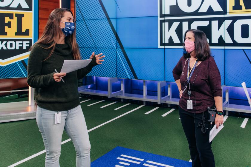 Fox NFL Kickoff director Courtney Stockmal, left, speaks to other producers in the show's studio.