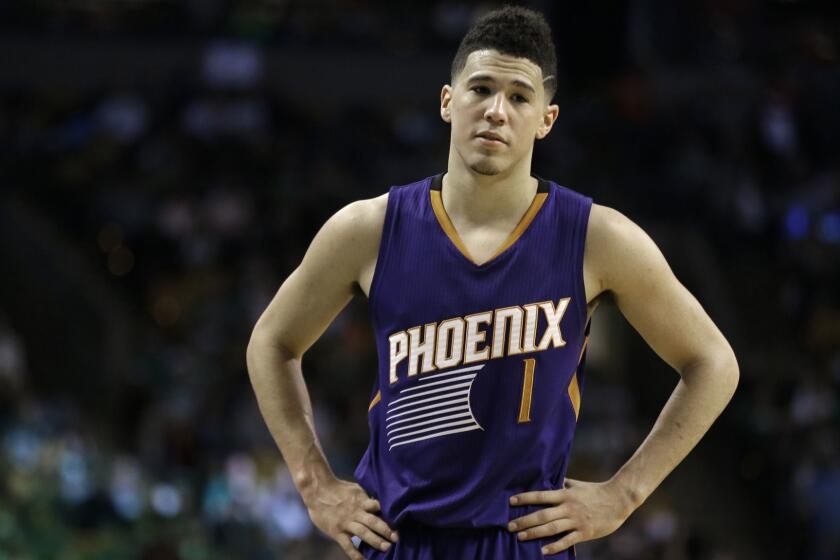 Phoenix Suns guard Devin Booker stands during an NBA basketball game against the Boston Celtics, Friday, March 24, 2017, in Boston. Booker scored 70 points, in their loss to the Celtics, 130-120. Booker is just the sixth player in NBA history to score 70 or more points in a game. (AP Photo/Elise Amendola) (BASKETBALL PRO)