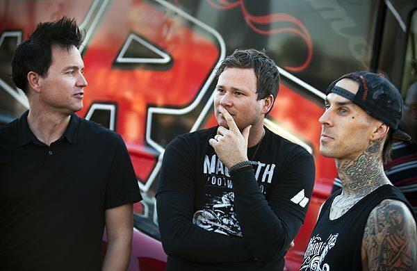 Blink-182 members bassist-vocalist Mark Hoppus, left, guitarist-vocalist Tom DeLonge and drummer Travis Barker participate in a promotional contest before their concert at the Honda Center in Anaheim.