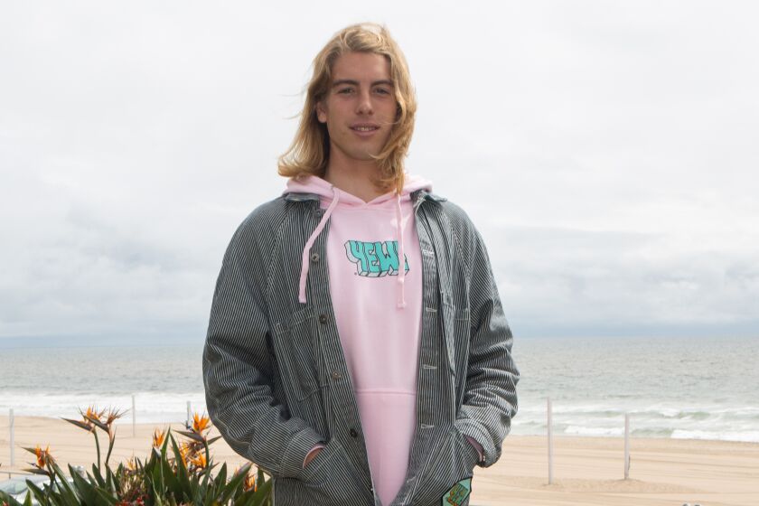 MANHATTAN BEACH, CA - MAY 12: Hogan Peters, 23, poses for a portrait on Tuesday, May 12, 2020 in Manhattan Beach, CA. His company usually makes wax for surf boards and hockey sticks but has switched over its operations to making hand soap and has donated the soap to El Camino College. (Gabriella Angotti-Jones / Los Angeles Times)