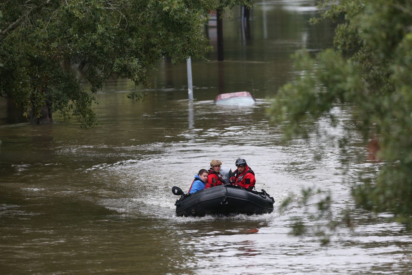 Daniel Gross, 15, is rescued by Houston police after he was stranded on top of his car in southwest Houston.