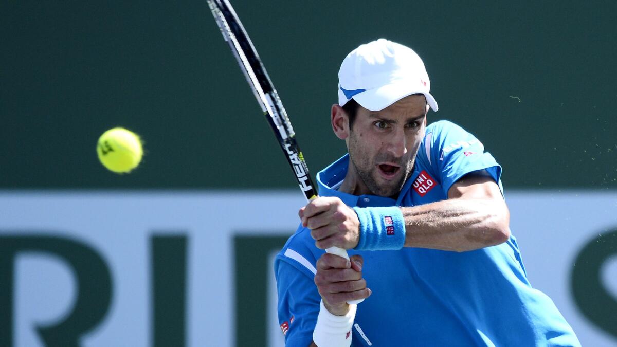 Novak Djokovic returns a shot against Milos Raonic during the men's final at the BNP Paribas Open in Indian Wells on Sunday.