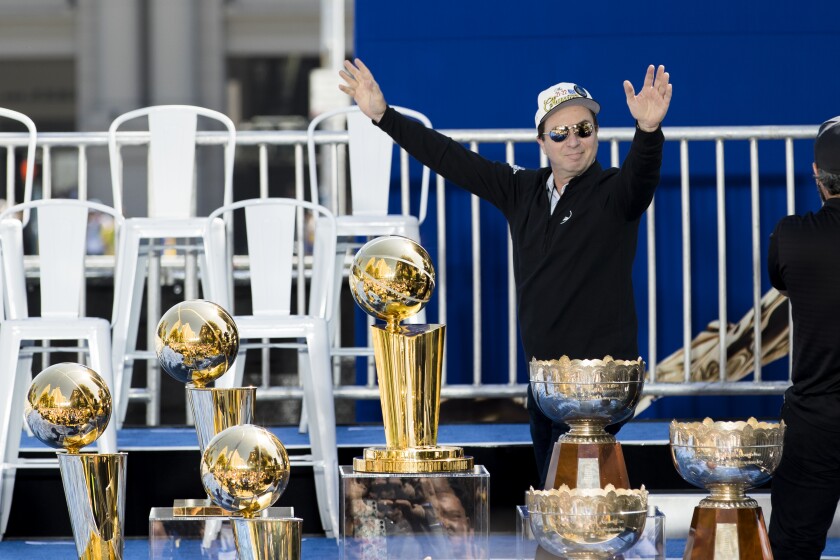 Golden State Warriors owner Joe Lacob gestures to the crowd.