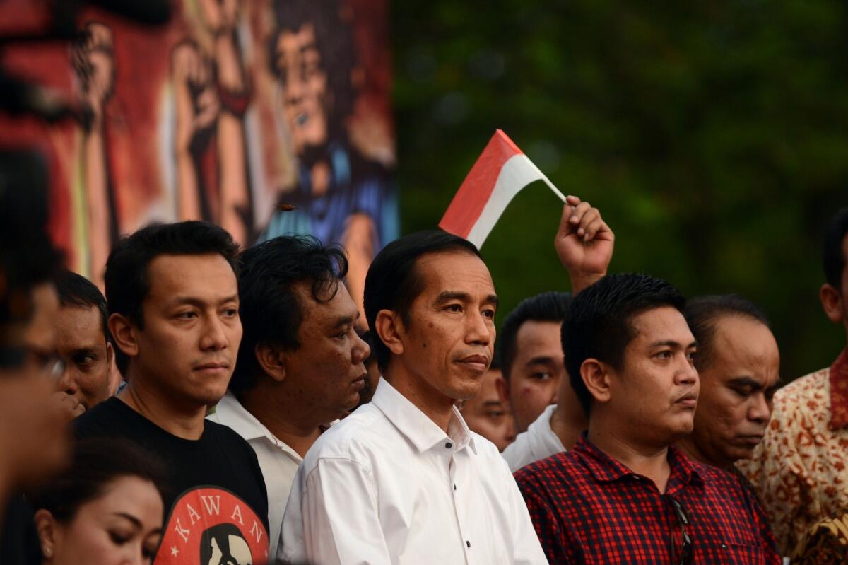 After a tense two-week ballot recount in Indonesia's closest ever race for the top job, election officials declared the popular governor of Jakarta, Joko "Jokowi" Widodo, center, the winner in the July 9 presidential election.