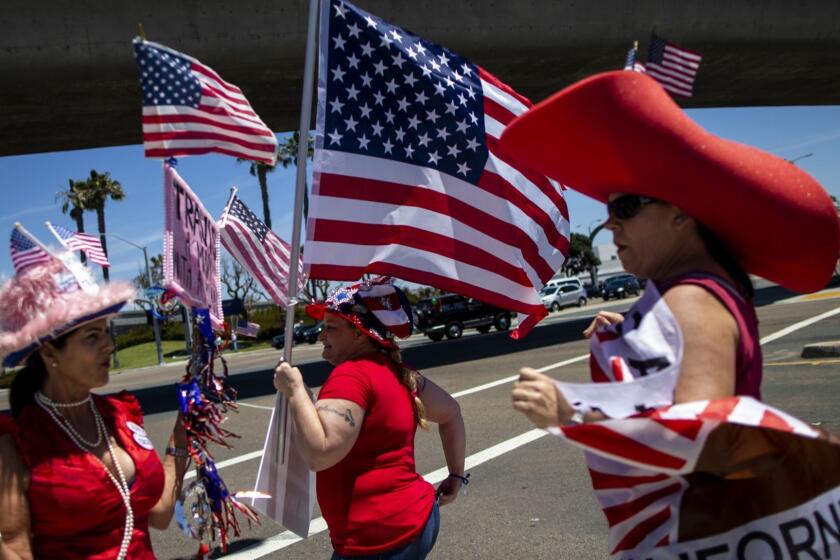 SAN DIEGO, CALIF. - MAY 05: Supporters of Republican gubernatorial candidate Travis Allen hold flags and campaign signs at a rally on Day 02 of the 2018 California Republican Party Convention and Candidate Fair at the Sheraton San Diego Hotel & Marina on Saturday, May 5, 2018 in San Diego, Calif. (Kent Nishimura / Los Angeles Times)