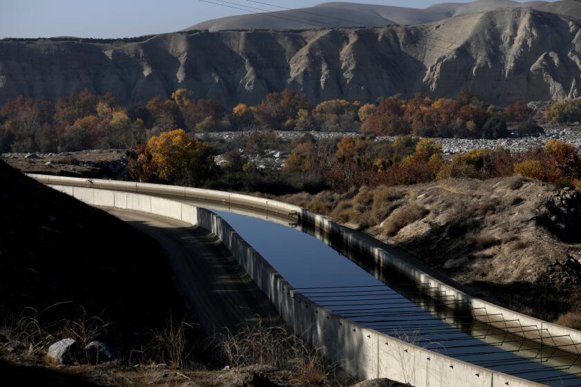 BAKERSFIELD, CA - DECEMBER 01: Rio Bravo hydroelectric power plant, left, with the Kern River in the background along SR 178 on Wednesday, Dec. 1, 2021 in Bakersfield, CA. The power plant uses water from the Kern River to generate power. People in Bakersfield press the California Department of Water Resources board to bring back a flowing Kern River. The river has long been dry in downtown because so much water is diverted. (Gary Coronado / Los Angeles Times)