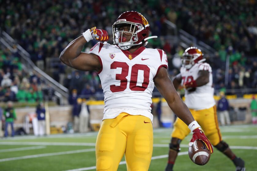 Southern California running back Markese Stepp flexes his bicep after scoring on a 2-yard touchdown run in the second half of an NCAA college football game against Notre Dame in South Bend, Ind., Saturday, Oct. 12, 2019. (AP Photo/Paul Sancya)