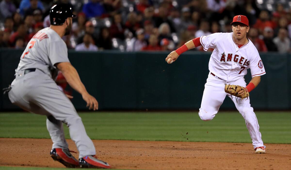 St. Louis Cardinals' Matt Holliday, left, is called out for leaving the baseline trying to elude Angels' Cliff Pennington during the third inning on Tuesday.