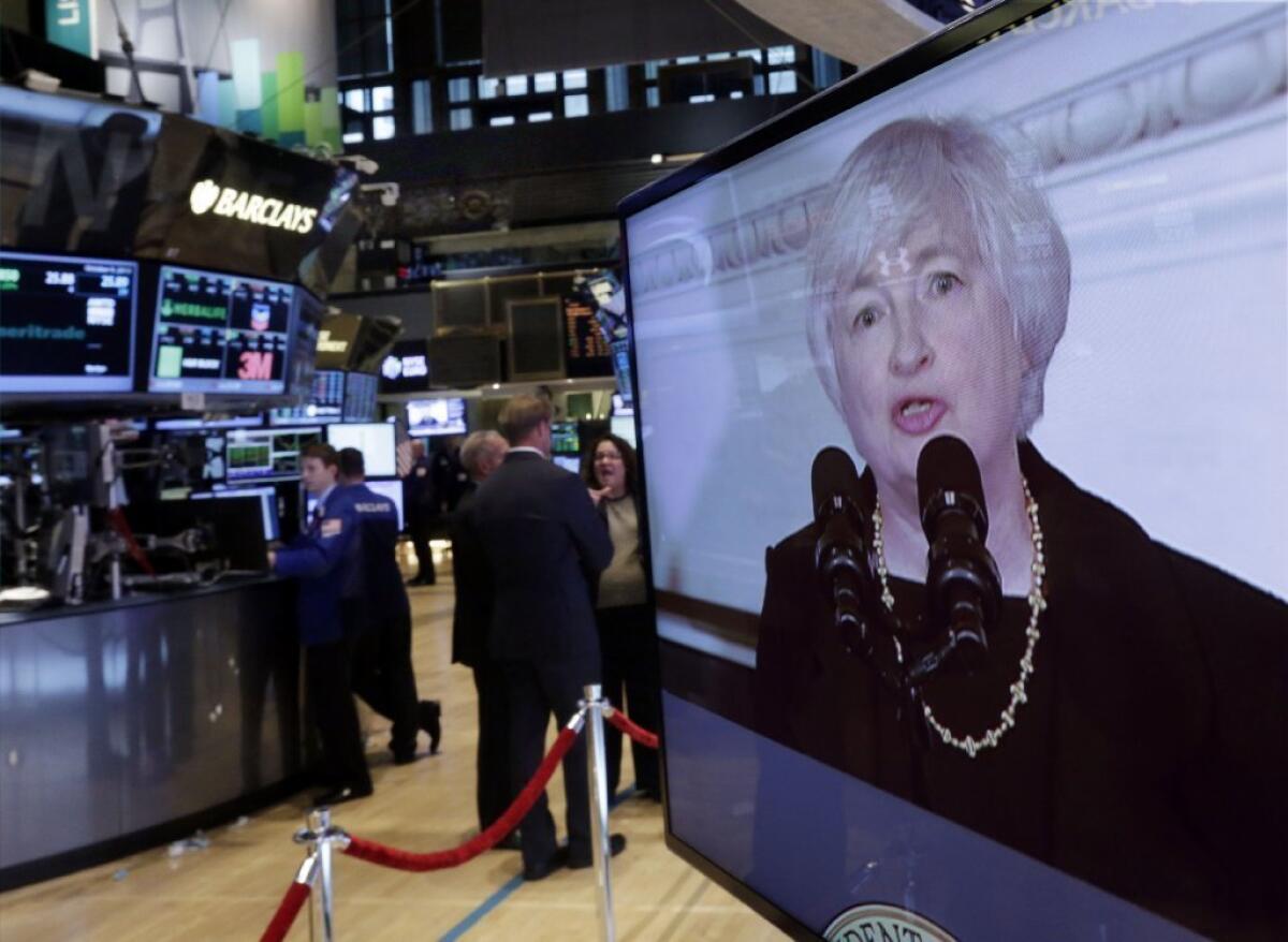 Traders work on the floor of the New York Stock Exchange on Oct. 9 as news is broadcast of Janet Yellen's nomination by President Obama to chair the Federal Reserve.