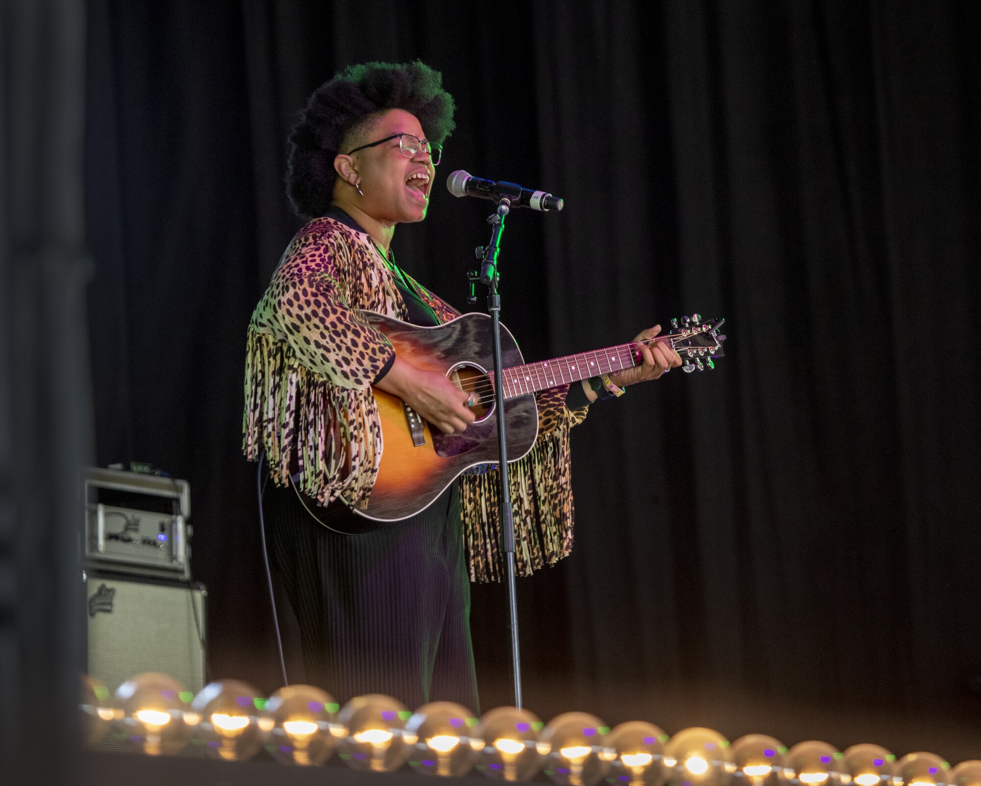 Amythyst Kiah plays the guitar and sings onstage