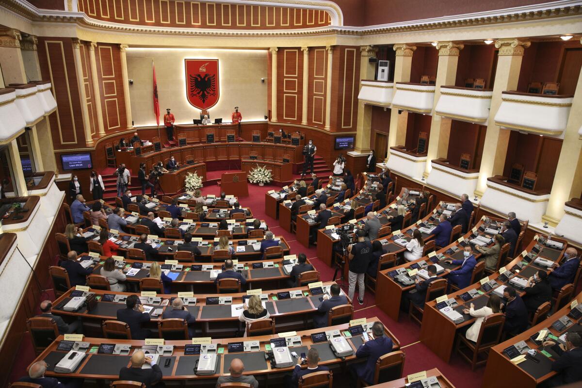 Albanian Lawmakers take part in a parliament session in Tirana, Friday, Sept. 10, 2021. Albania's prime minister on Thursday announced his new cabinet in which women form the majority, keeping most of his previous government's officials but naming new finance and justice ministers.(AP Photo/Franc Zhurda)