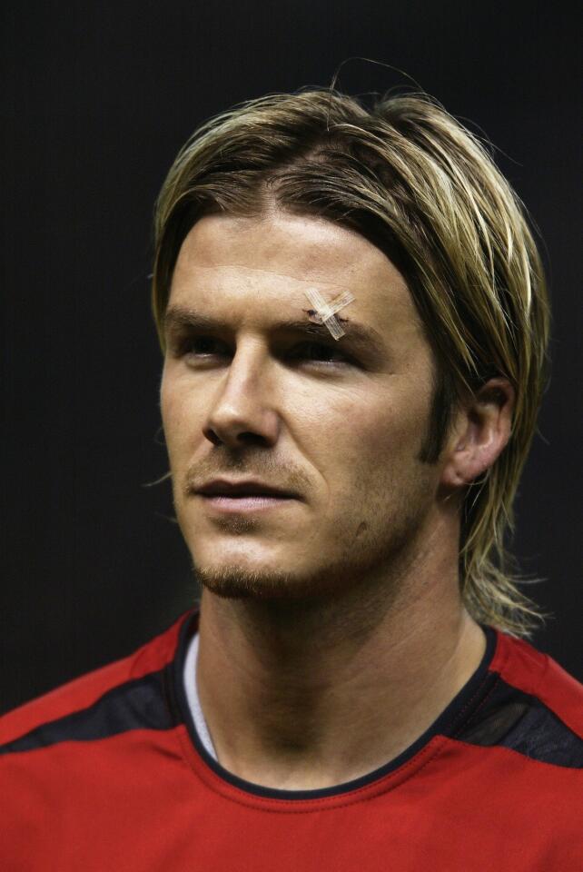 David Beckham sported long hair during a soccer match in 2003.
