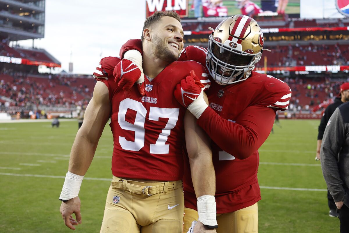 San Francisco 49ers defensive end Nick Bosa (97) celebrates with offensive tackle Trent Williams after the 49ers defeated the New Orleans Saints in an NFL football game in Santa Clara, Calif., Sunday, Nov. 27, 2022. (AP Photo/Jed Jacobsohn)