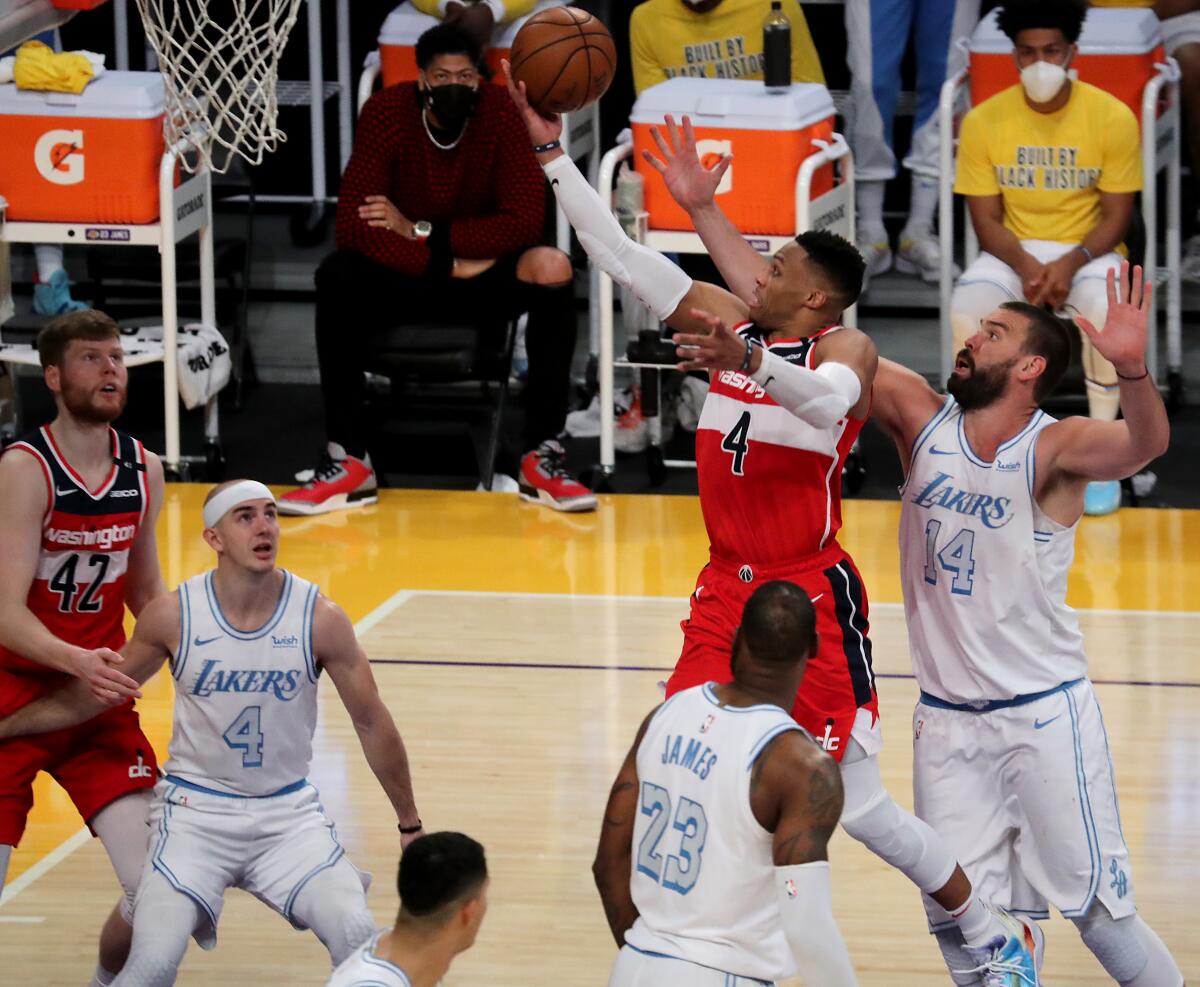 Wizards guard Russell Westbrook drives and scores against Lakers center Marc Gasol in overtime.