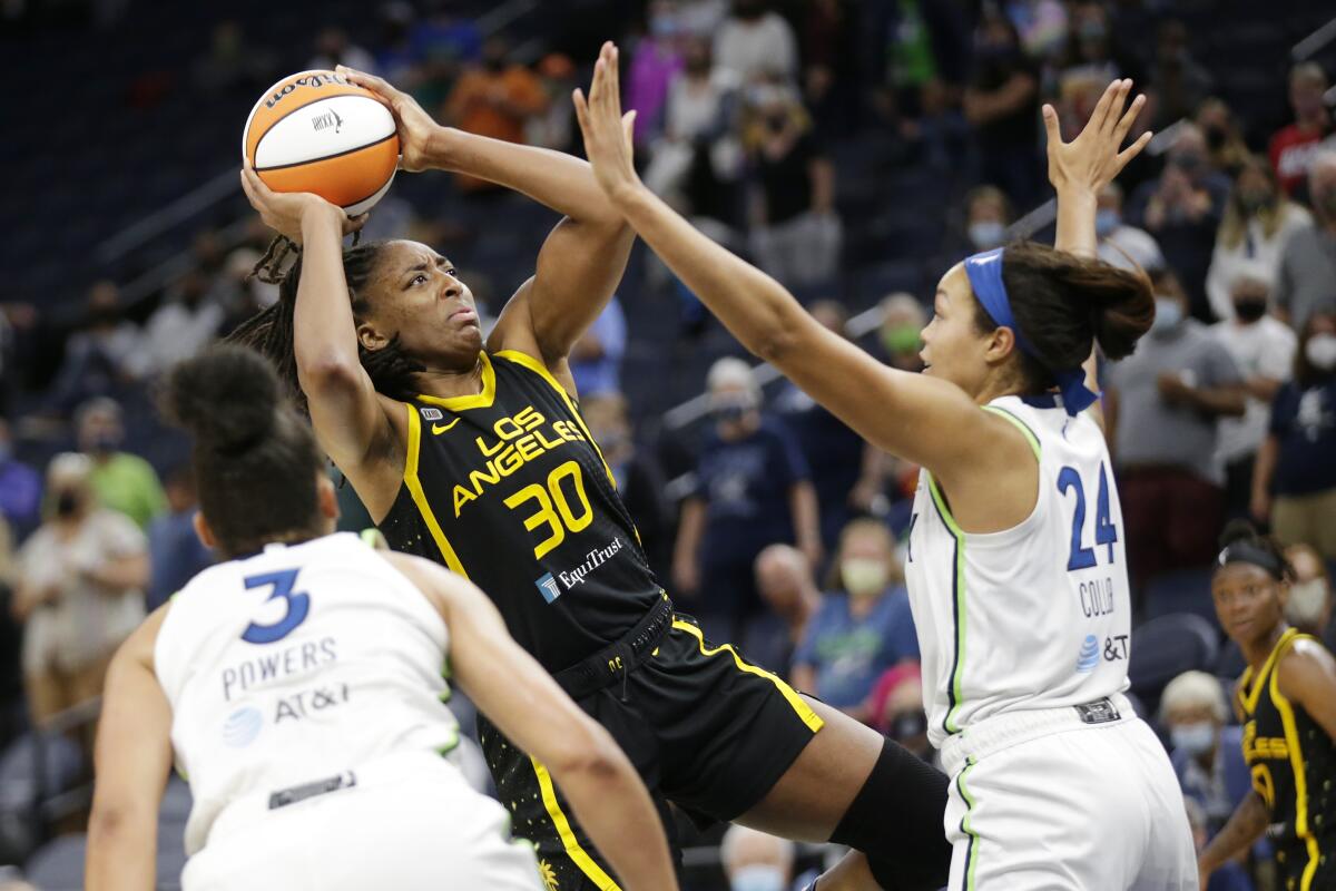 Sparks forward Nneka Ogwumike shoots over Minnesota Lynx forward Napheesa Collier and forward/guard Aerial Powers.