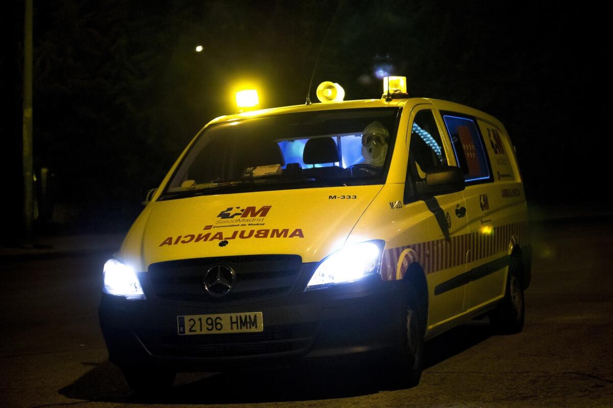 A paramedic in a protective suit drives to the Carlos III Hospital on Friday in Madrid.