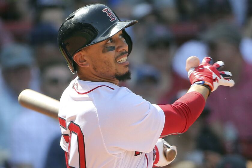 Boston Red Sox's Mookie Betts follows through with his third home run of the game in the seventh inning of a baseball game against the Kansas City Royals at Fenway Park, Wednesday, May 2, 2018, in Boston. (AP Photo/Elise Amendola)